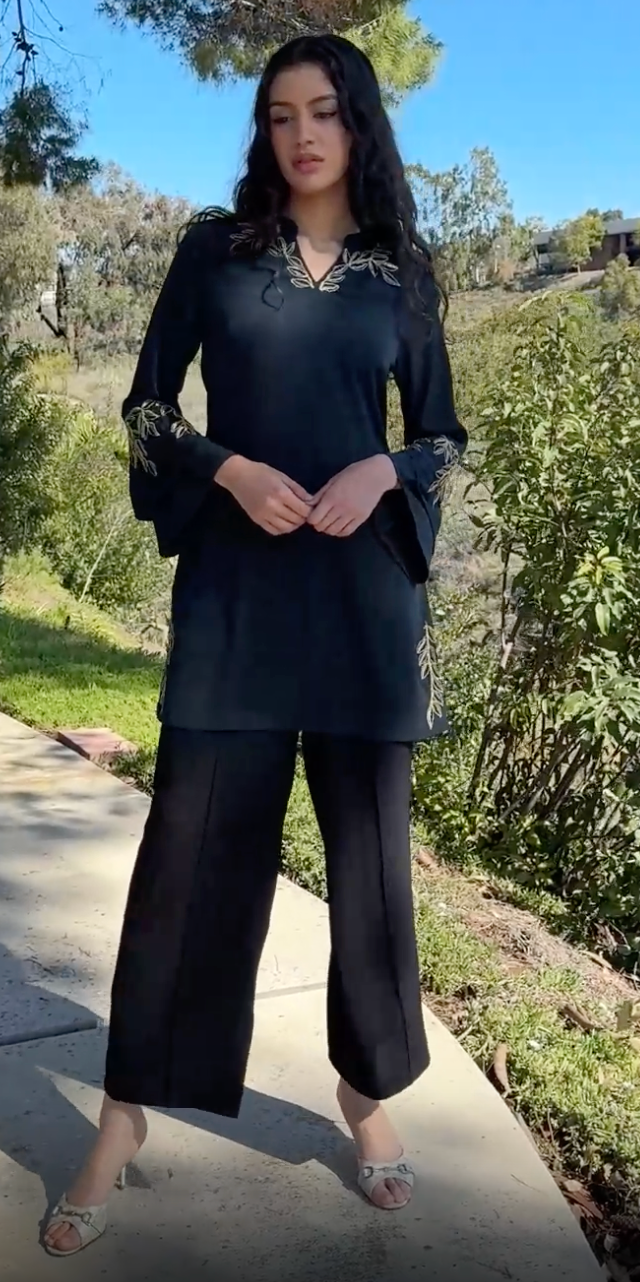 Woman outside wearing Arzoo tunic in Dark Teal with black pants and heels. 