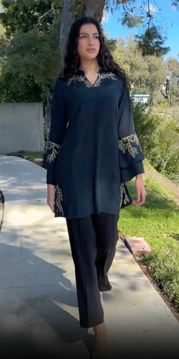 Woman outside looking to the side wearing Arzoo tunic in Dark Teal. 