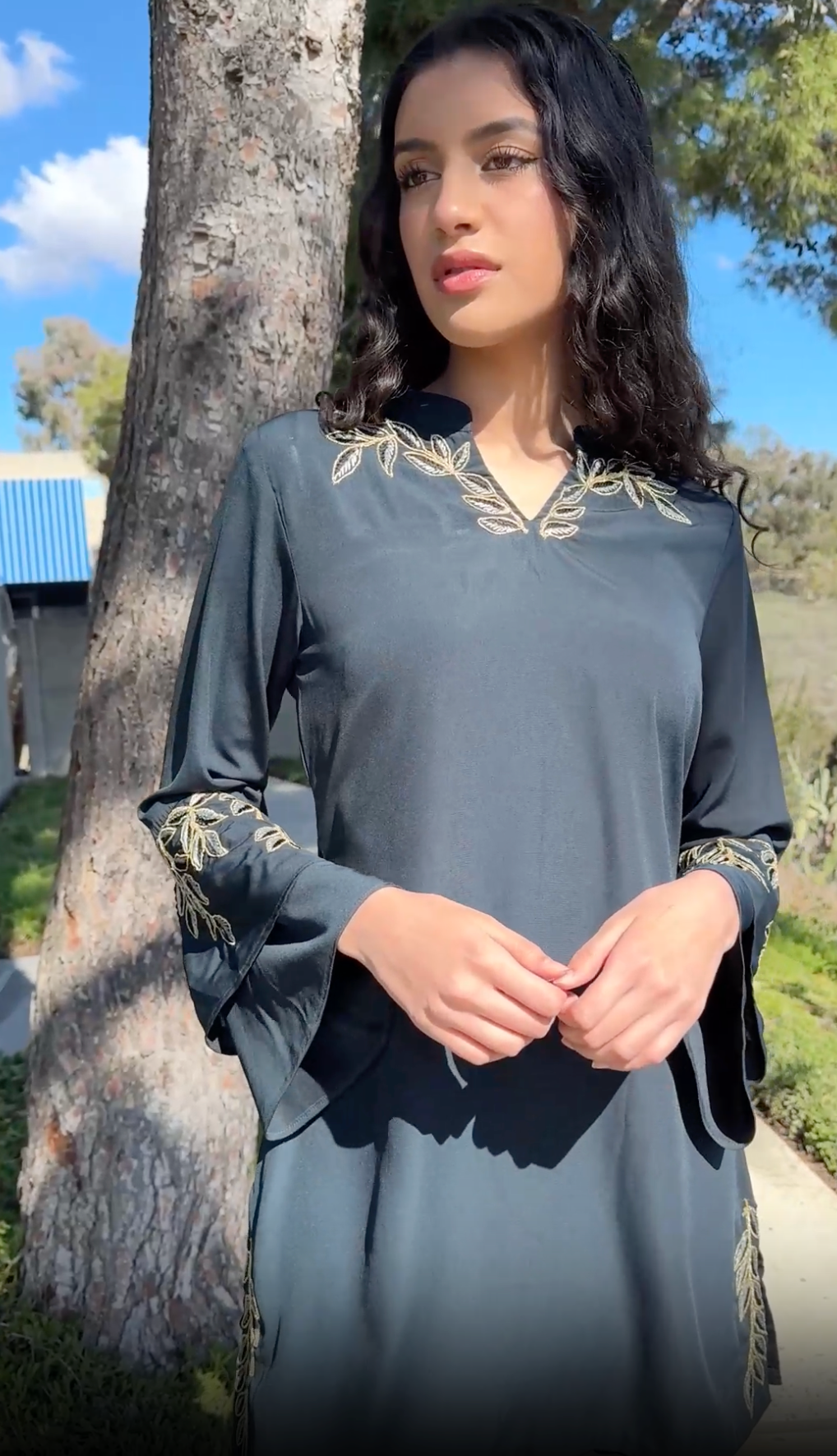 Woman outside wearing Arzoo tunic in Dark Teal. 