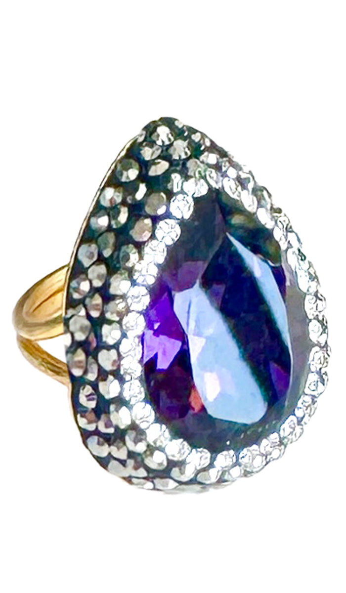 Side view of teardrop ring with purple jewel and CZ crystals.