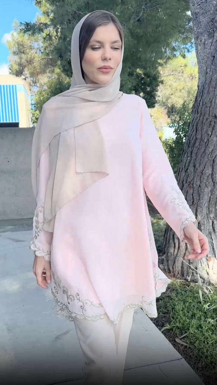 Model wearing hijab and modest Meena tunic in blush.