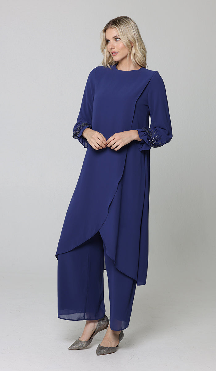 Three-quarter view of model wearing Safa tunic and pants set in blue.