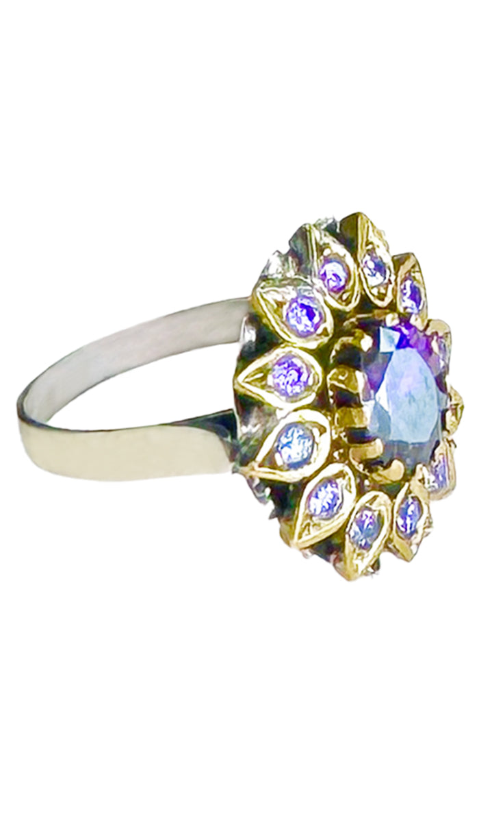 Side profile of purple jeweled ring with purple crystals.