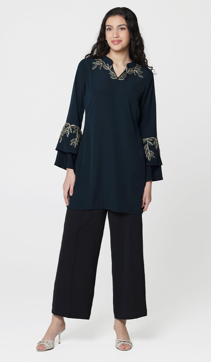 Smiling woman wearing Arzoo tunic in Dark Teal with black pants and heels. 