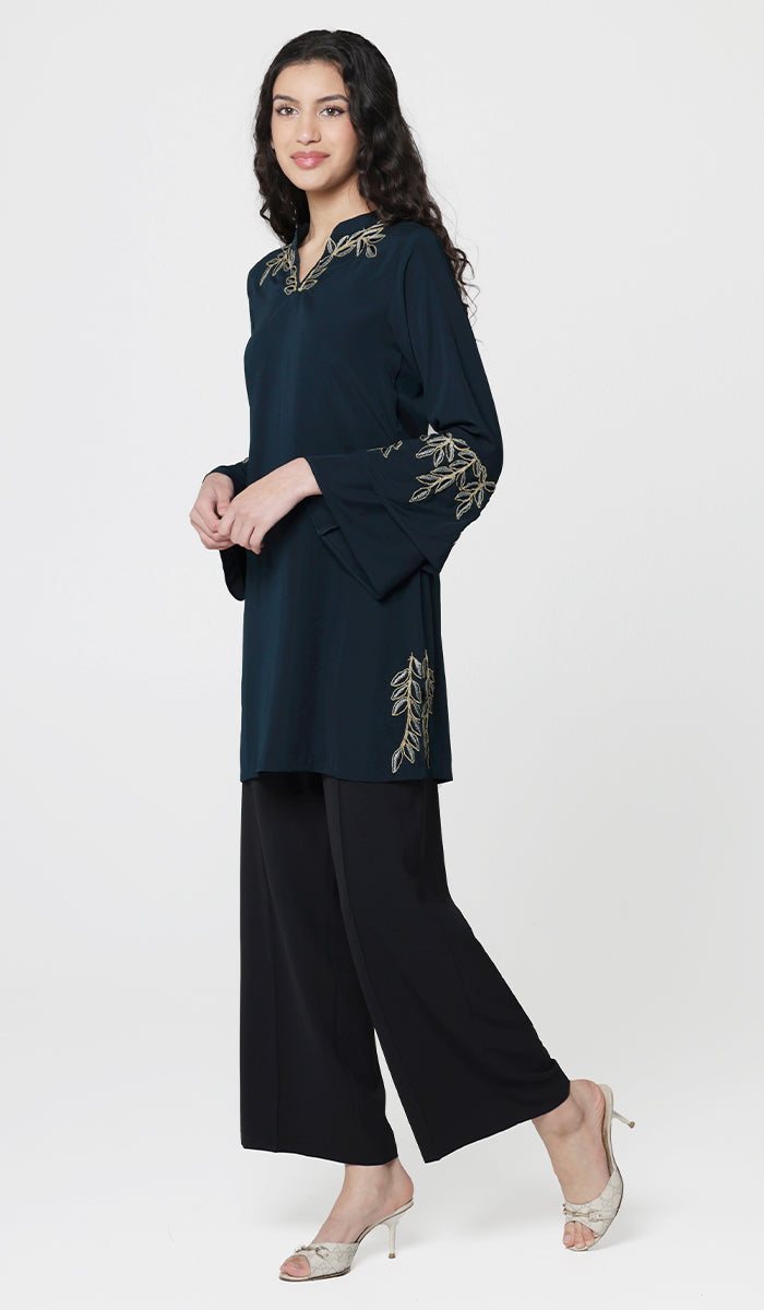 Smiling woman wearing modest Arzoo tunic in Dark Teal with black pants and heels. 