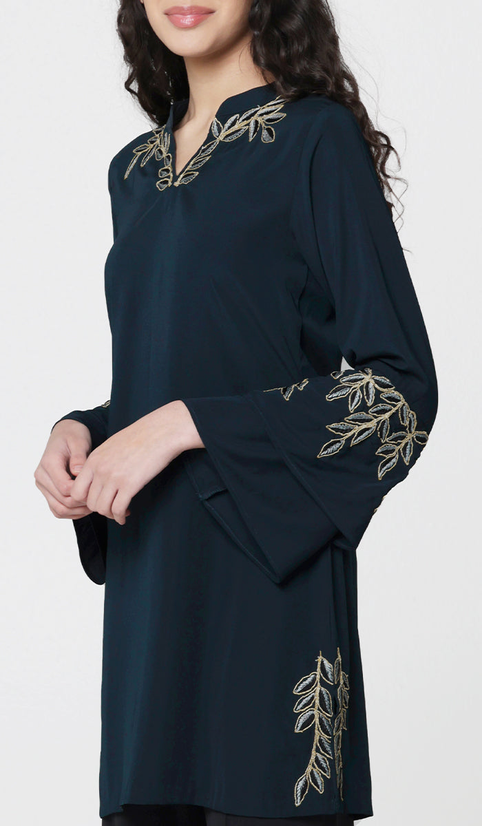 Side view of woman wearing modest Arzoo tunic in Dark Teal. 