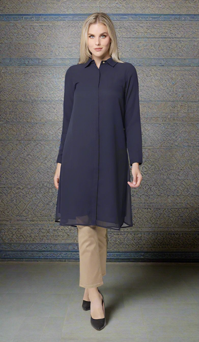 Woman wearing modest Asra tunic in Navy with khaki pants and heels. 