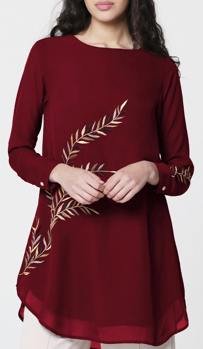 Woman wearing Baraka tunic in Ruby. 