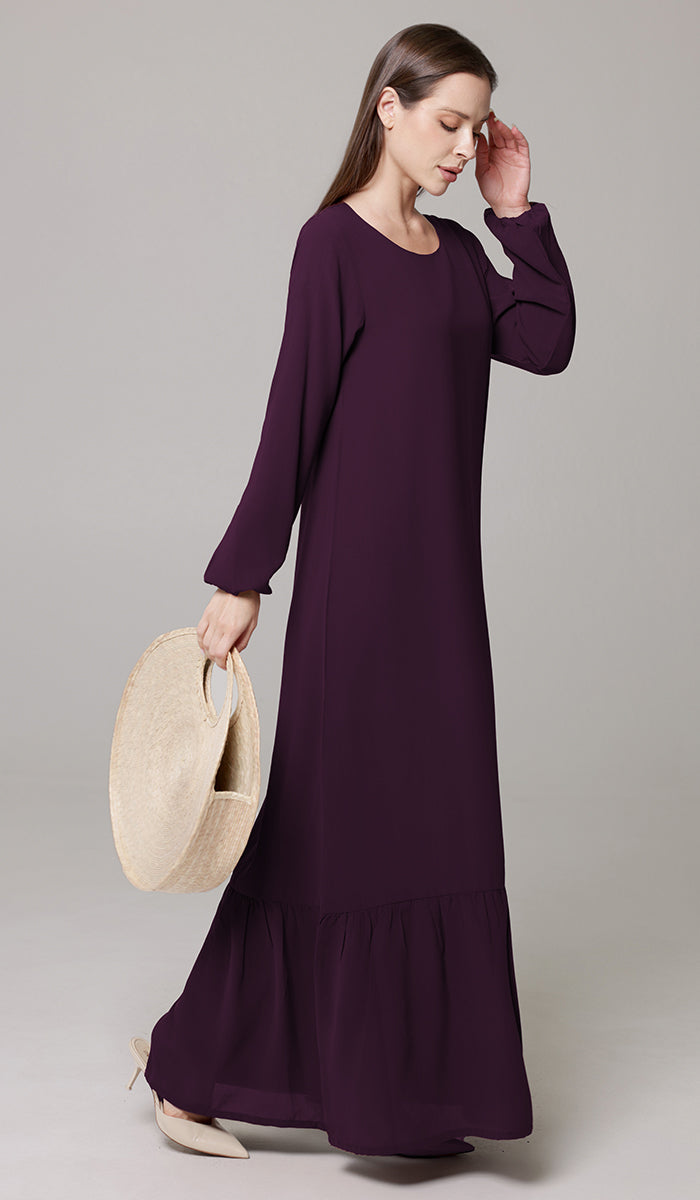 Woman wearing Batool dress in Mulberry. 