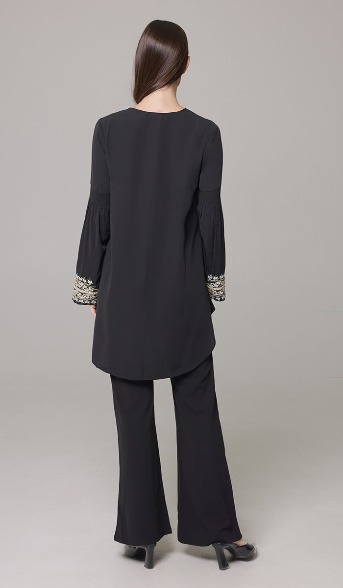 Back view of woman wearing Esme tunic in Black.