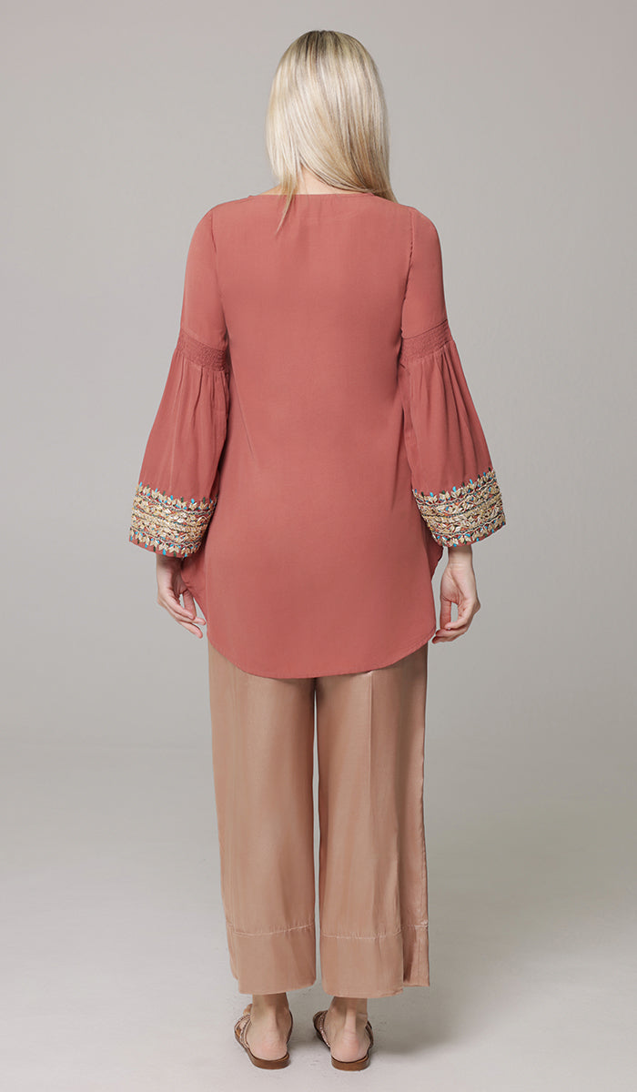 Back view of woman wearing Esme tunic in Rose. 