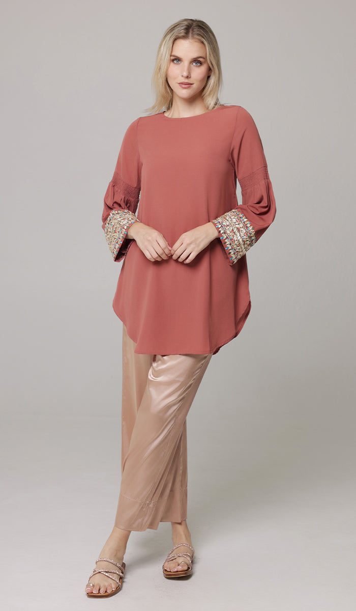 Woman wearing modest Esme tunic in Rose with Eva pants in Champagne. 