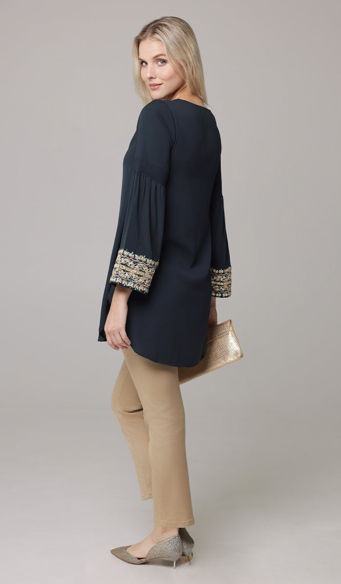 Woman looking over shoulder wearing modest Esme tunic in Dark Teal. 