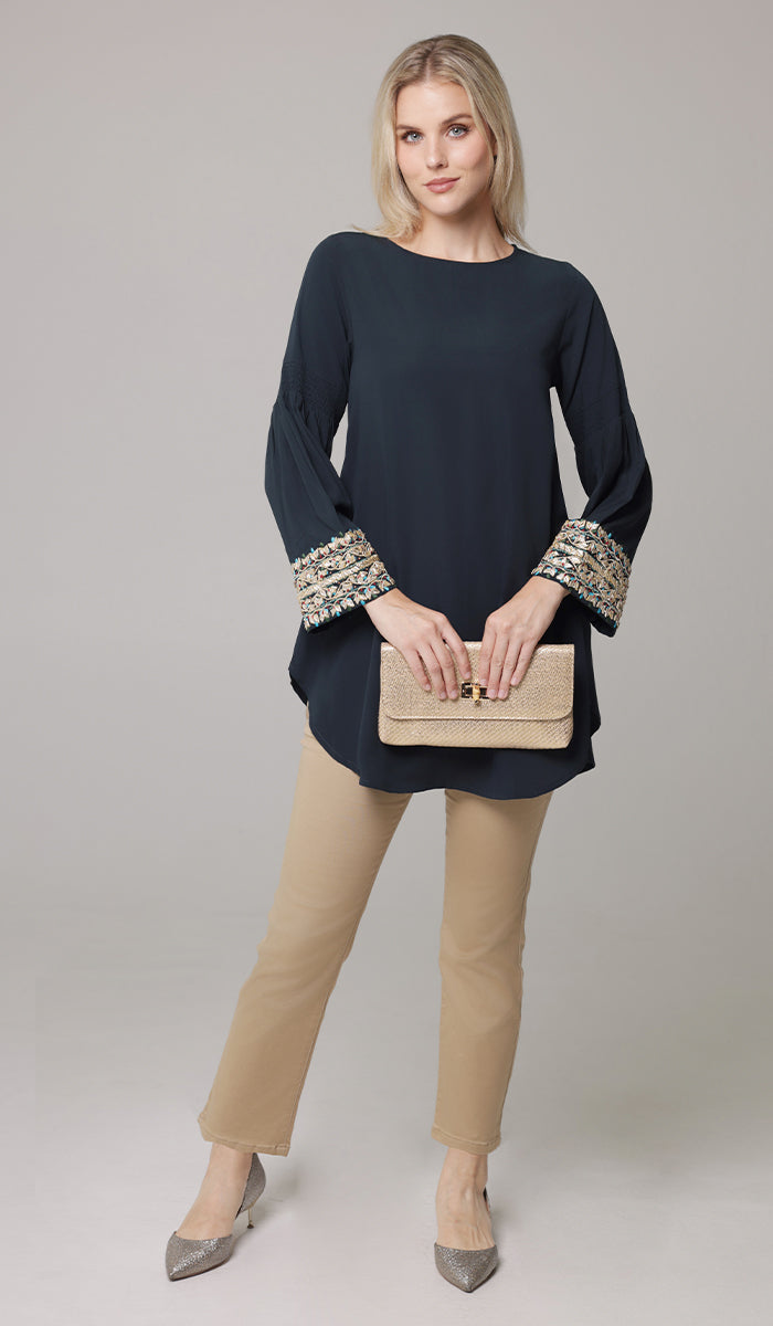 Woman wearing Esme tunic in Dark Teal with Erem pants. 