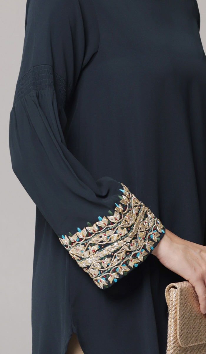 Close up view of embroidery detail of Esme tunic in Dark Teal. 