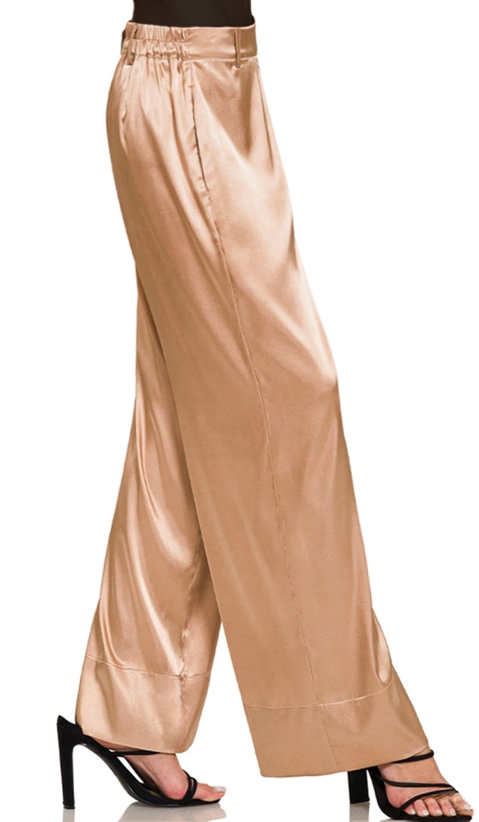 Side view of woman wearing Eva pants in Champagne. 