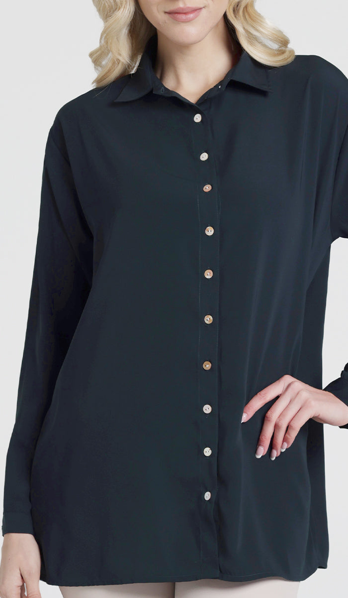 Female model wearing a dark teal Hania boxy button down.