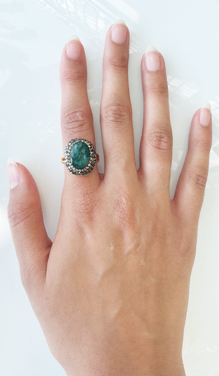 Hand wearing raw jade ring.