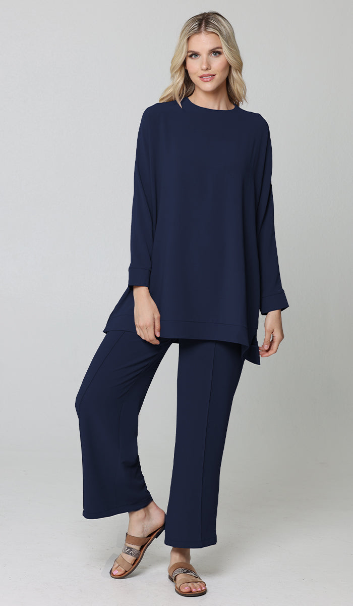 Woman wearing modest Marvi tunic in Blue with Marvi pants and sandals. 