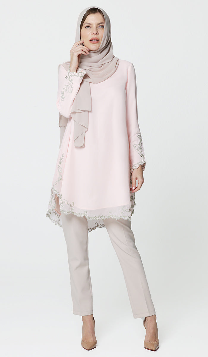 Model posing in hijab, pink Meena embroidered tunic, pants and heels.