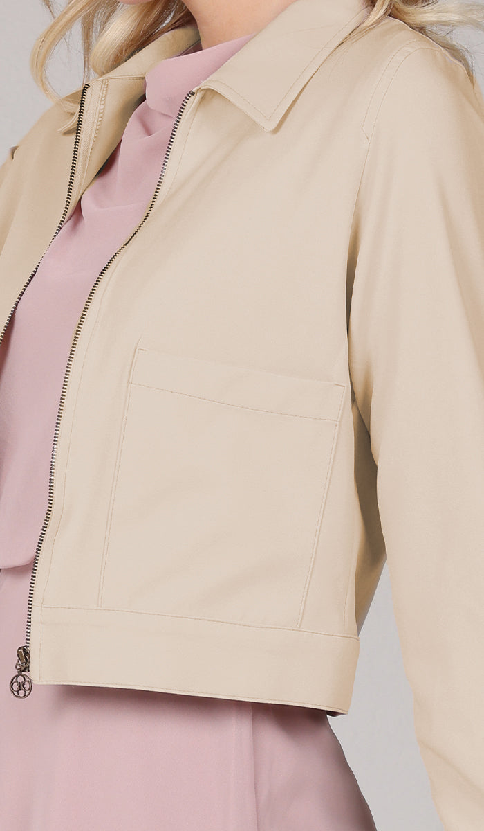 close up view of tan jacket with pocket.