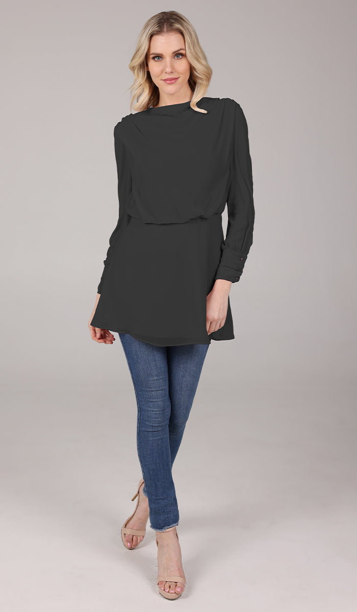 Woman smiling wearing modest Myra tunic in Black with jeans and heels. 