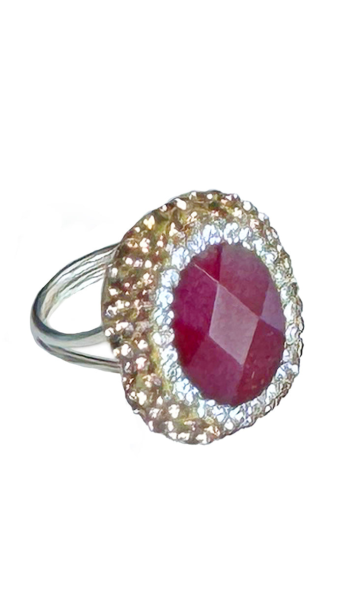 Side view of oval ruby with silver and gold crystals.