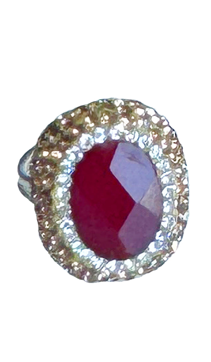 Oval ruby with silver and gold crystals.