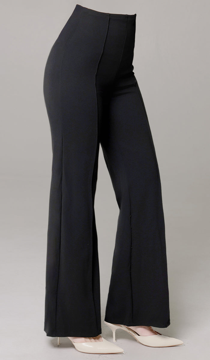 Side view of woman wearing Riva pants in Black. 