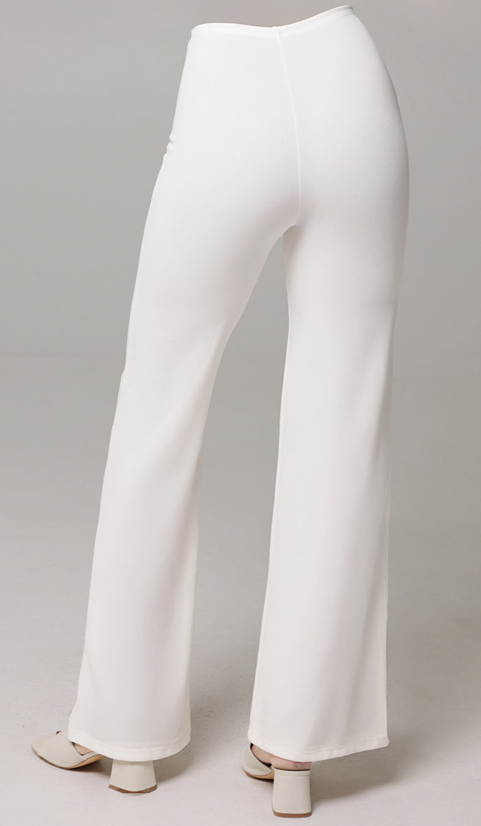 Back view of woman wearing Riva pants in White. 