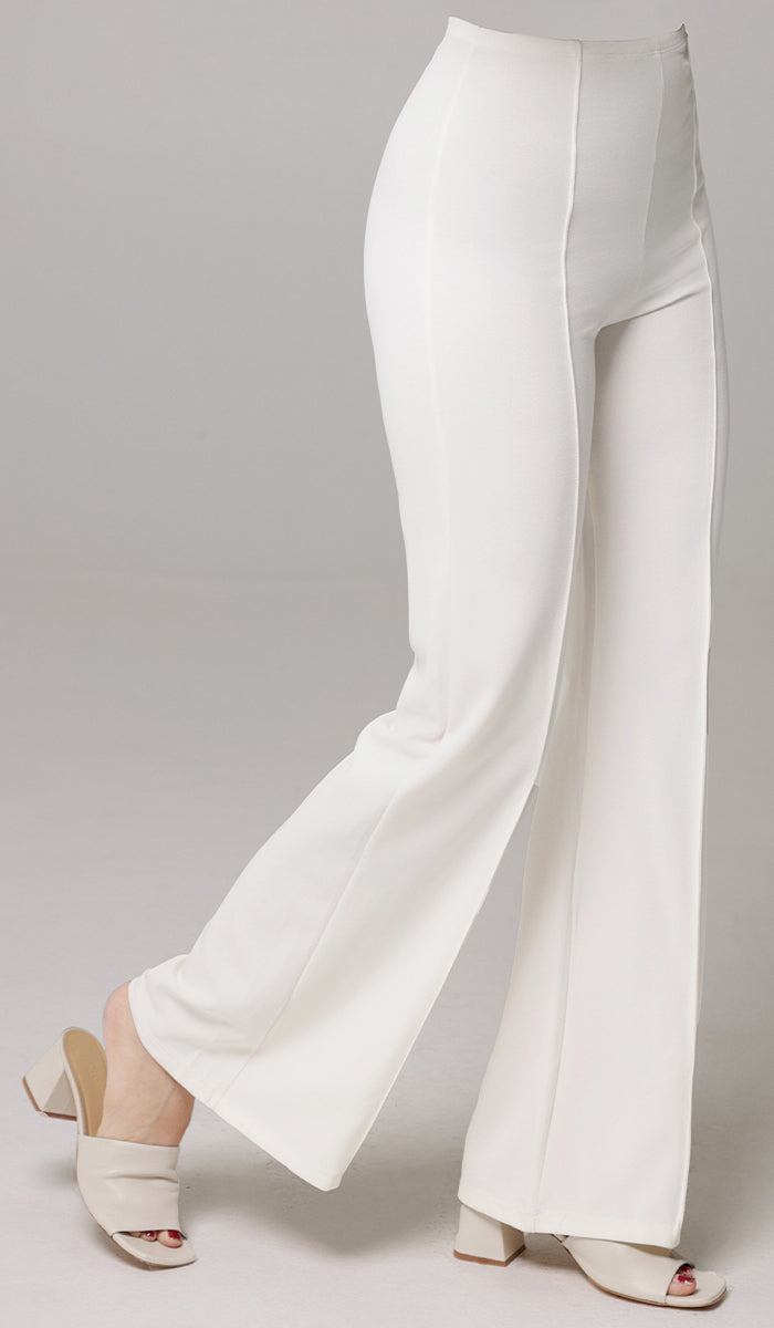 Side view of woman wearing Riva pants in White. 