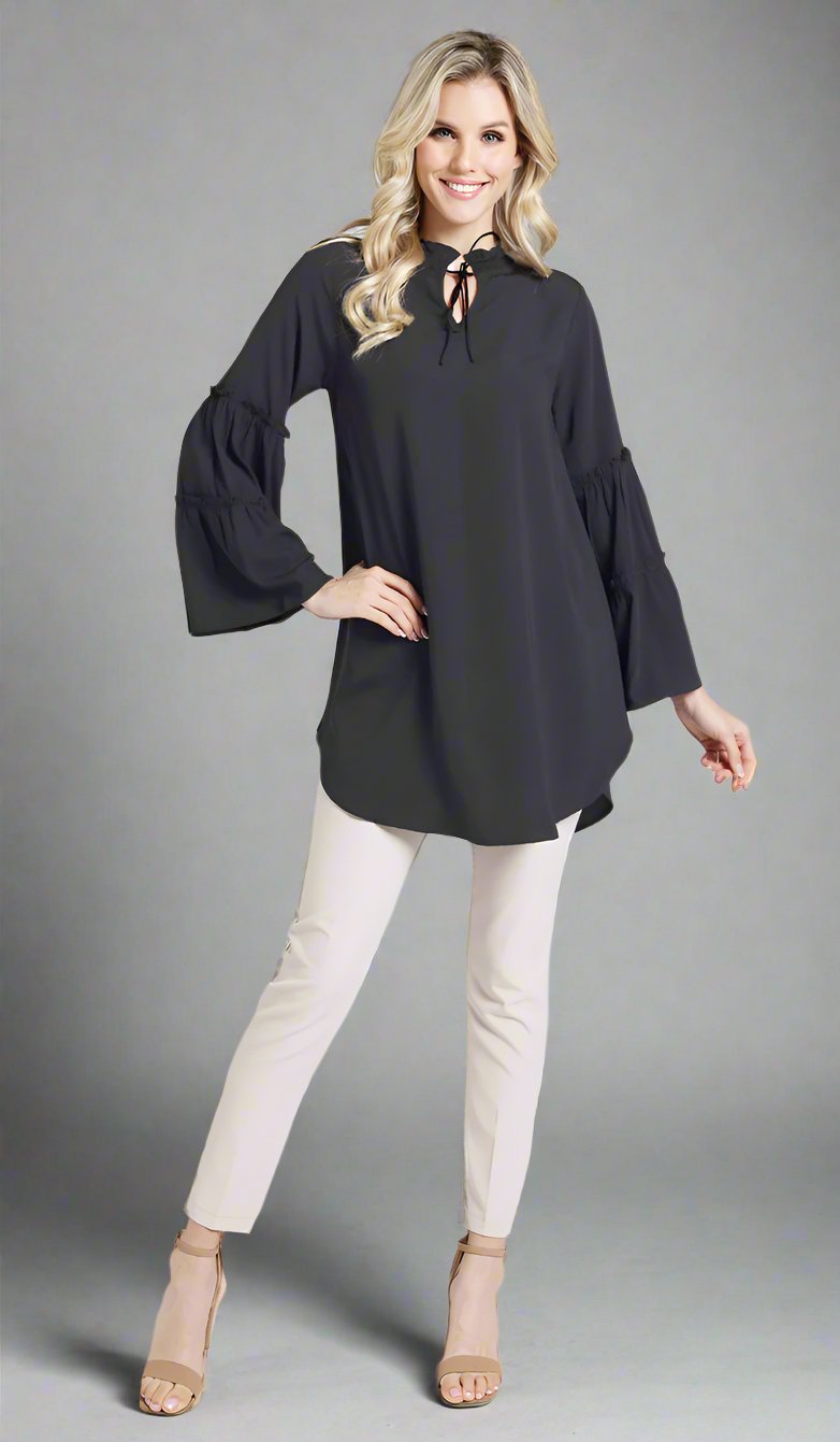 Smiling woman wearing modest Saba tunic in Black with Alma pants and heels. 