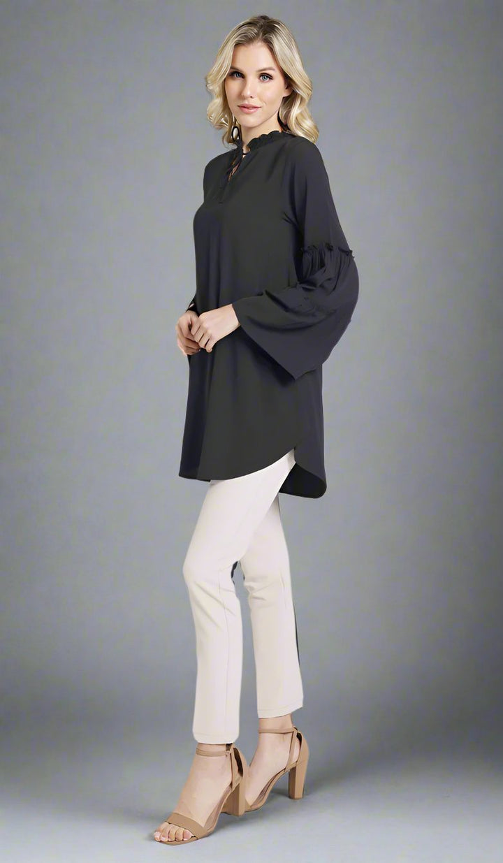 Woman wearing modest Saba tunic in Black with Alma pants and heels. 