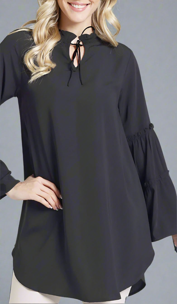 Smiling woman wearing modest Saba tunic in Black.