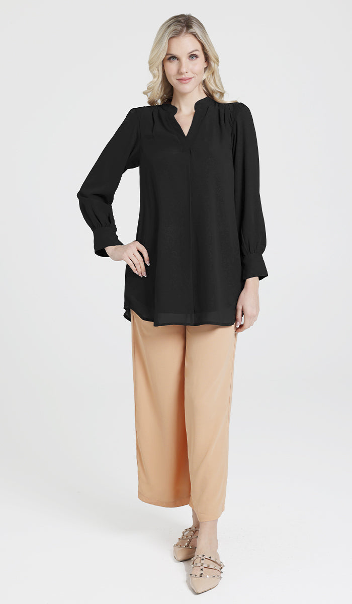 Woman wearing Shaina tunic in Black with Ula pants and flats. 