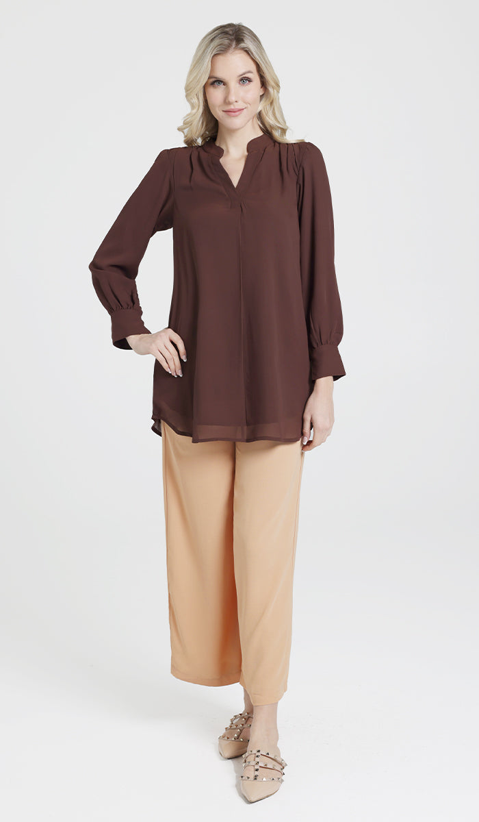 Full body front view of model wearing a brown chiffon Shaina top with light orange Ula pants.