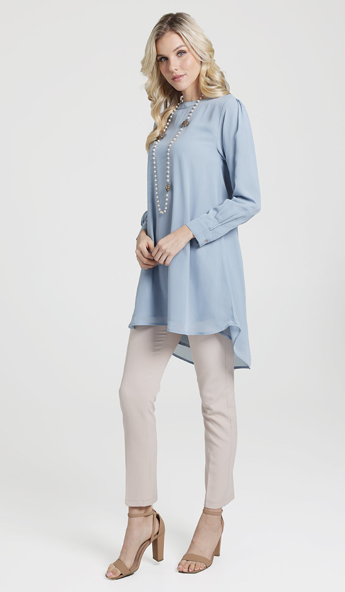 Woman wearing modest Sukoon long flowy chiffon tunic dress in Powder Blue.