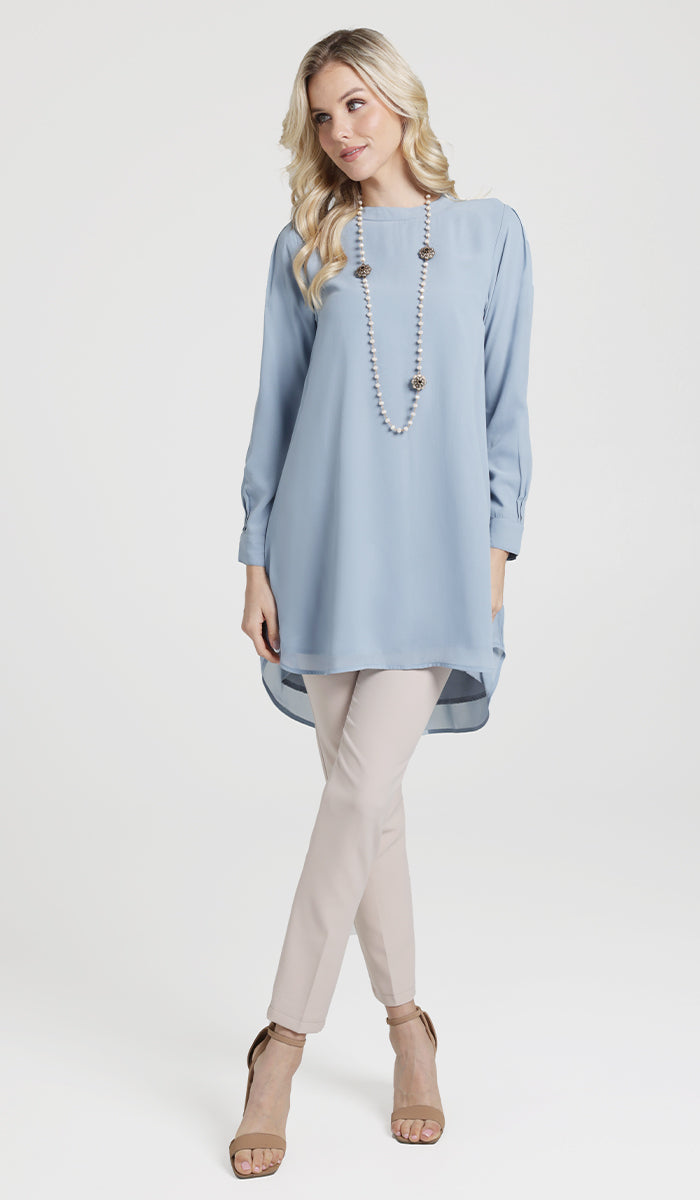 Woman wearing modest Sukoon chiffon tunic dress in Powder Blue. 