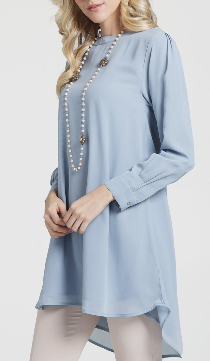 Woman wearing Sukoon long flowy chiffon tunic dress in Powder Blue.