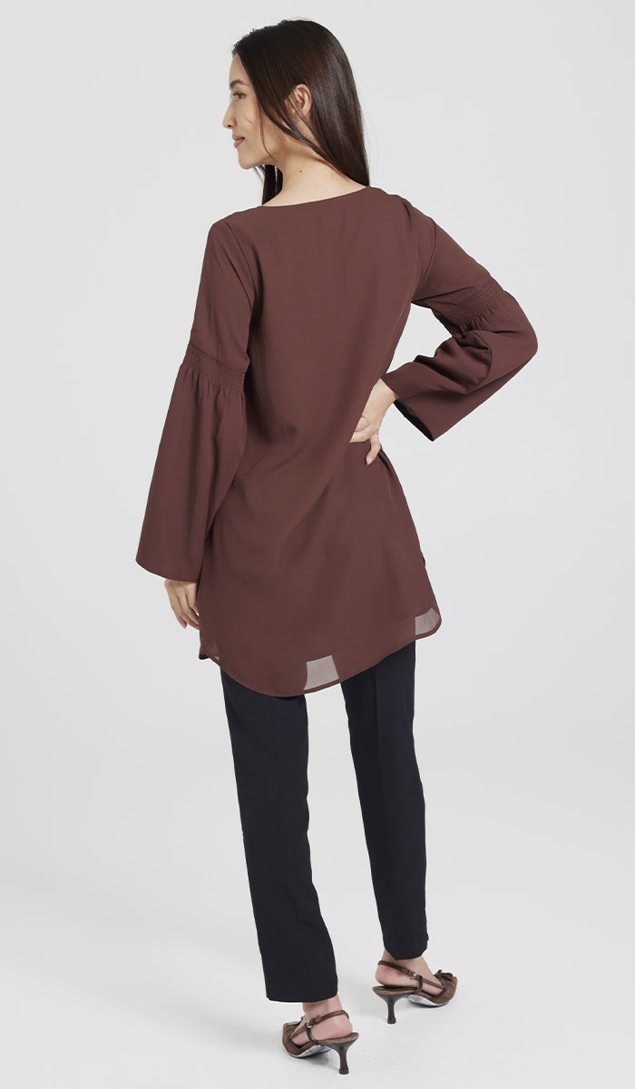 Back view of model wearing brown modest tunic. 