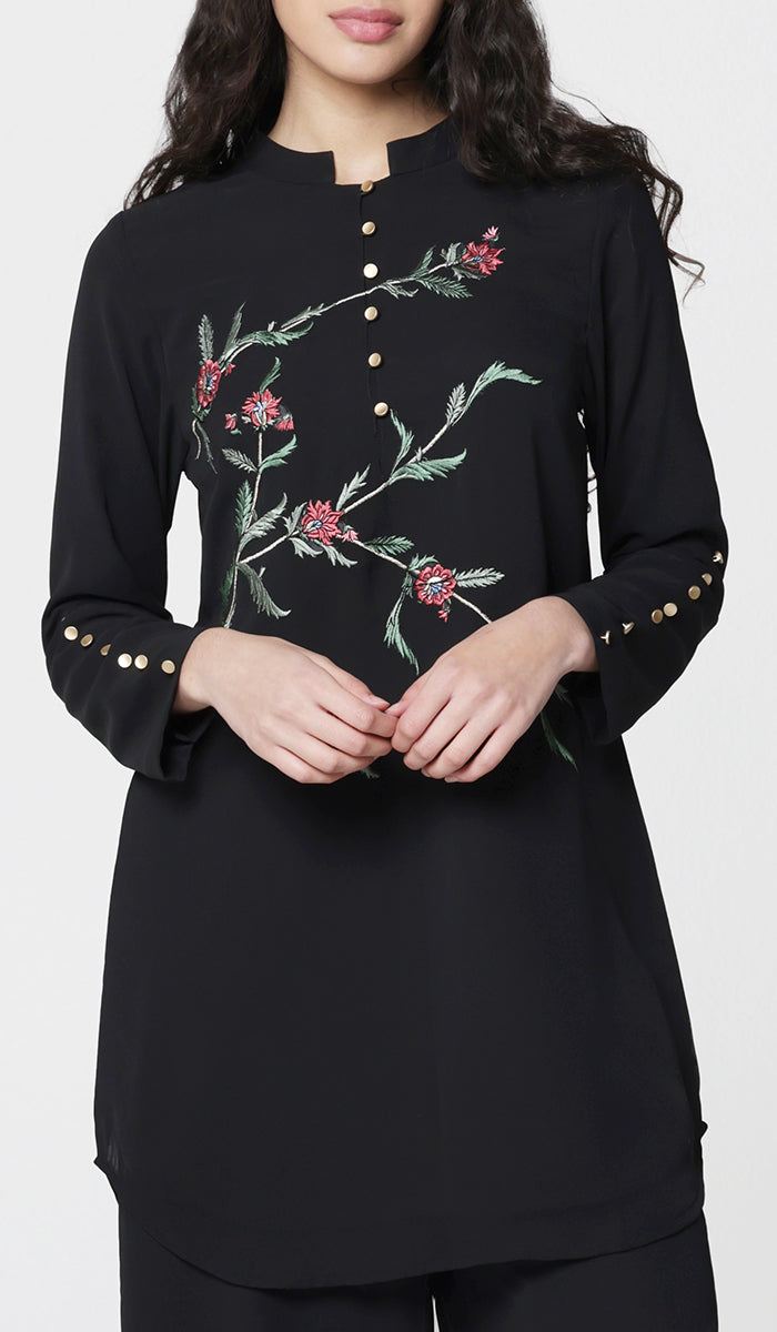 Woman wearing modest Uzma embroidered tunic in Black.