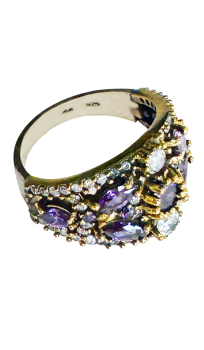 Side view of sterling ring with purple and clear crystals.