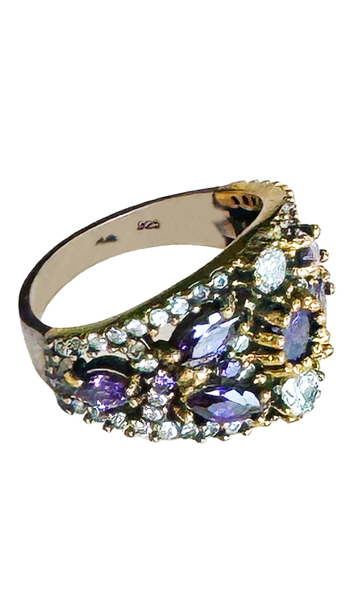 Side profile of sterling ring with purple and clear crystals.