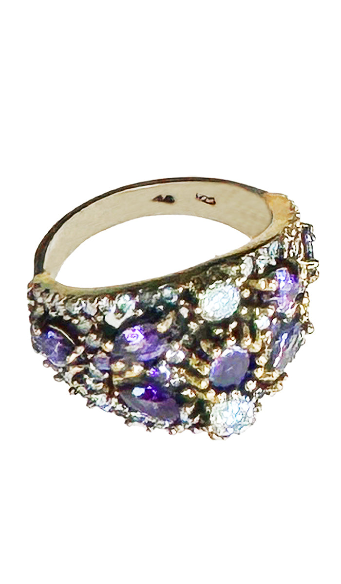 Top view of sterling ring with purple and clear crystals.