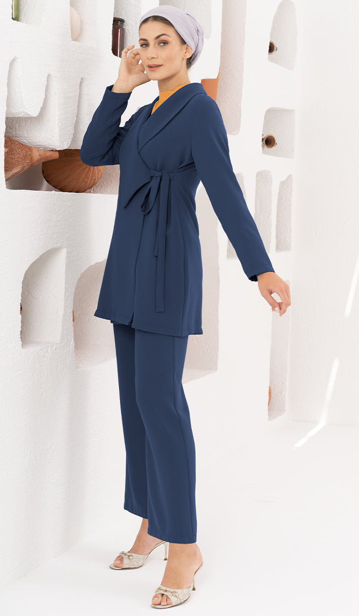 Woman in front of shelves wearing Abeer modest set in Marina Blue with heels.