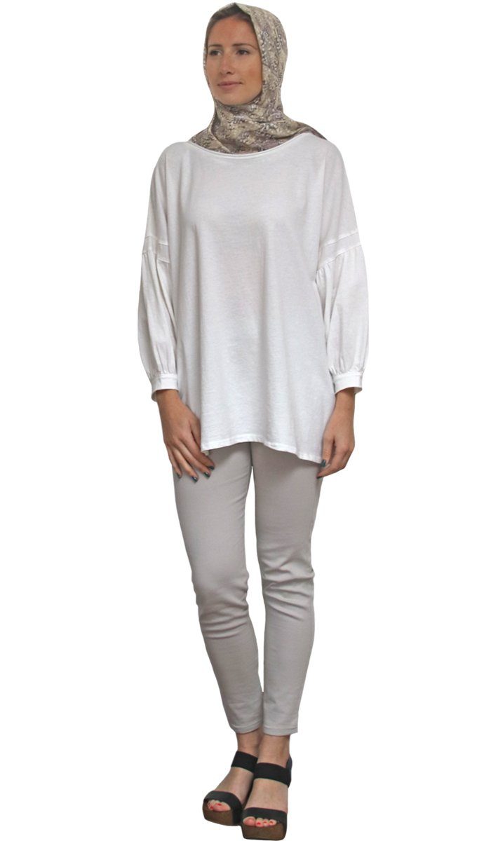 Woman wearing Aly Long Loose Modest Stretch Top in Cream.