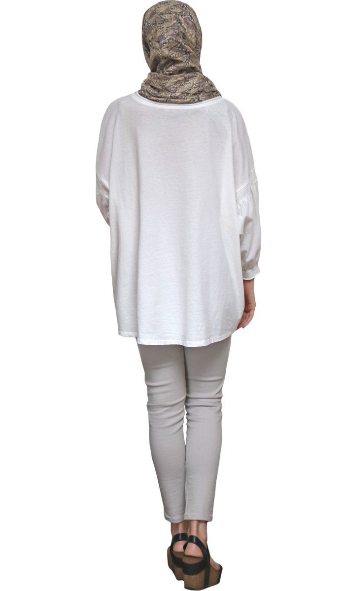 Back view of Aly Long Loose Modest Stretch Top in Cream. 