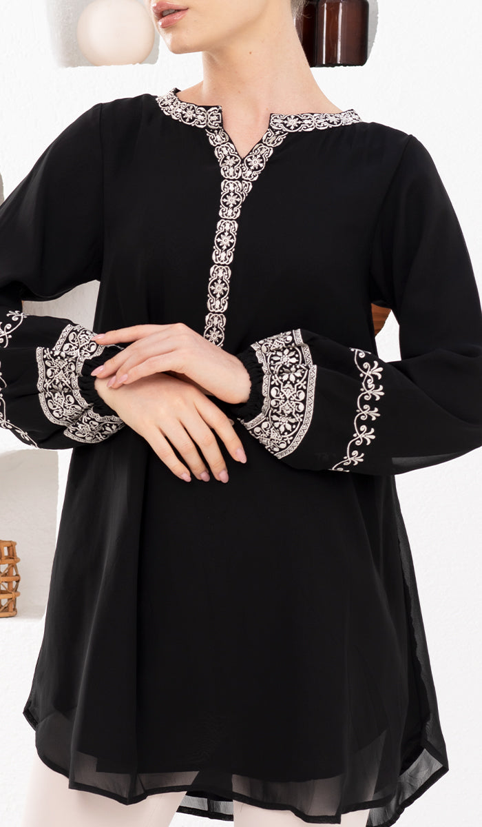 Model with hands in front of her wearing modest Amalie tunic in Black.