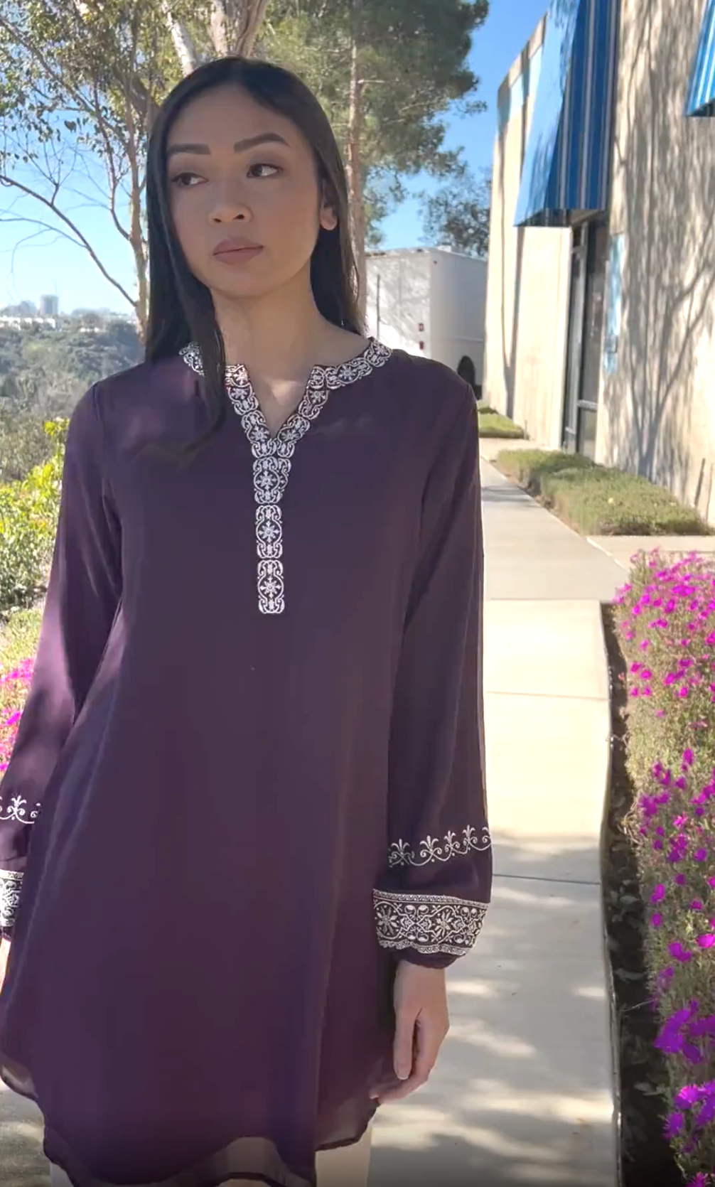 Woman outside wearing Amalie tunic in Eggplant. 