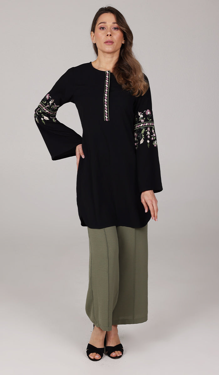 Model wearing modest Gulzar tunic in Black with Tina pants in Olive and black shoes. 